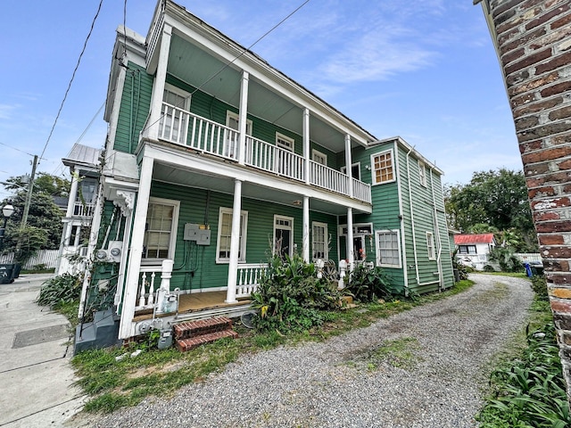 view of front facade with covered porch and a balcony