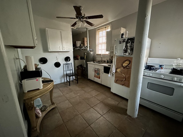 kitchen with white cabinetry, dark tile patterned floors, white range with gas stovetop, and ceiling fan