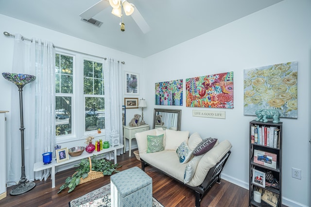 sitting room featuring dark wood-type flooring and ceiling fan