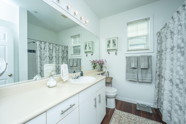 bathroom featuring vanity, hardwood / wood-style flooring, toilet, and a shower with shower curtain