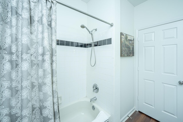 bathroom featuring shower / bathtub combination with curtain and hardwood / wood-style flooring