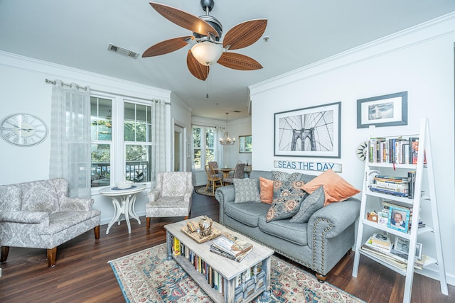 living room featuring dark hardwood / wood-style flooring, crown molding, and ceiling fan with notable chandelier