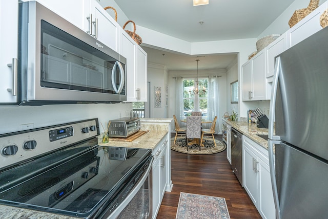 kitchen featuring light stone countertops, dark wood-type flooring, stainless steel appliances, and white cabinets