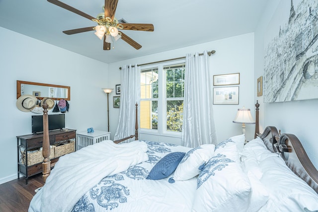 bedroom with dark hardwood / wood-style floors and ceiling fan