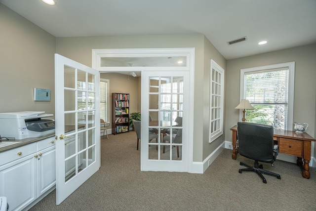 carpeted office with french doors