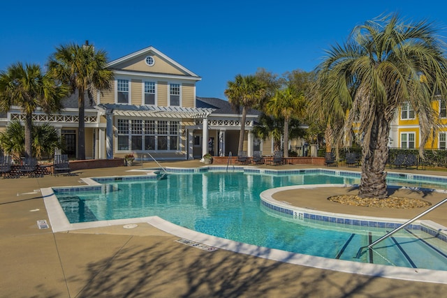 view of swimming pool featuring a pergola and a patio