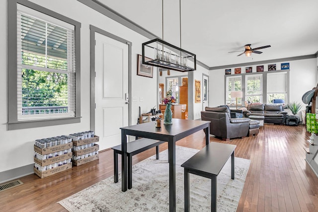 dining space with ornamental molding, a wealth of natural light, ceiling fan, and light hardwood / wood-style floors