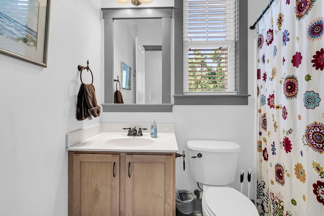 bathroom with vanity, toilet, and a shower with shower curtain