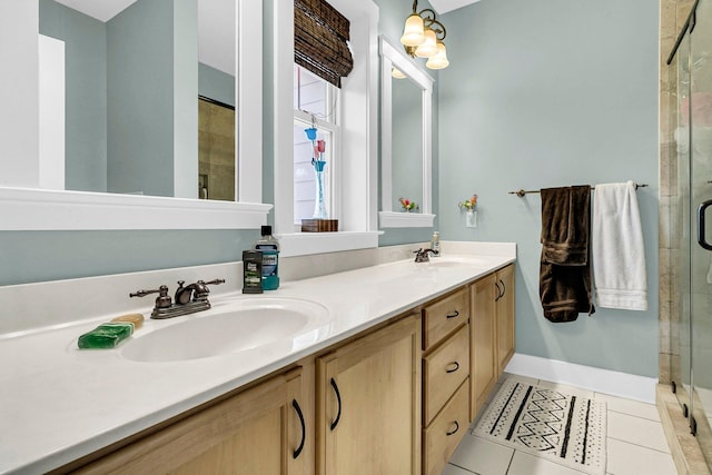 bathroom featuring vanity, a shower with shower door, and tile patterned floors