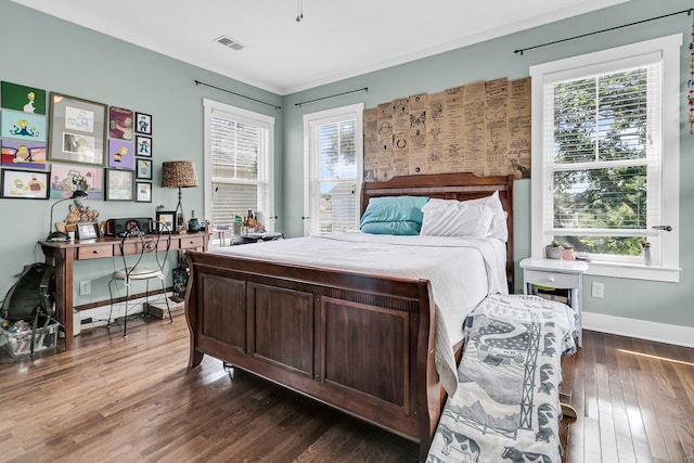 bedroom featuring dark wood-type flooring and multiple windows