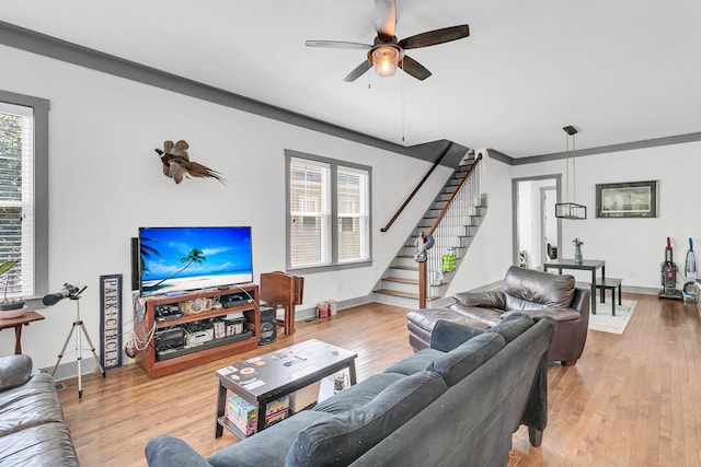 living room with ceiling fan, light hardwood / wood-style floors, and ornamental molding