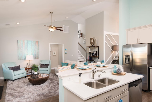 kitchen featuring a kitchen island with sink, sink, dark wood-type flooring, and stainless steel appliances