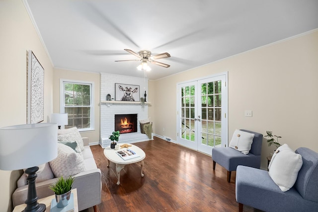 105 Spring St, Summerville, SC 29485 - living room featuring crown molding, plenty of natural light, ceiling fan, wood finished floors, and a brick fireplace
