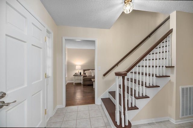 105 Spring St, Summerville, SC 29485 - staircase featuring a textured ceiling and tile patterned floors