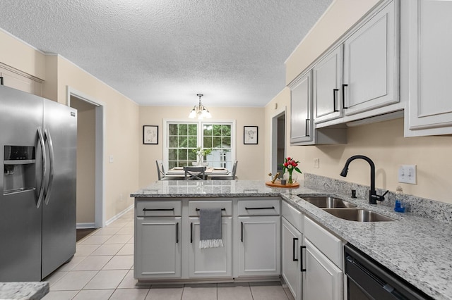 105 Spring St, Summerville, SC 29485 - kitchen with stainless steel fridge, a peninsula, dishwasher, a chandelier, and light tile patterned floors