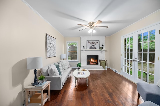 105 Spring St, Summerville, SC 29485 - living room featuring ceiling fan, crown molding, a brick fireplace, wood finished floors, and french doors