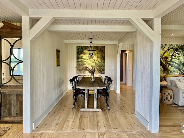 dining space with vaulted ceiling with beams, light wood finished floors, baseboards, and a wealth of natural light