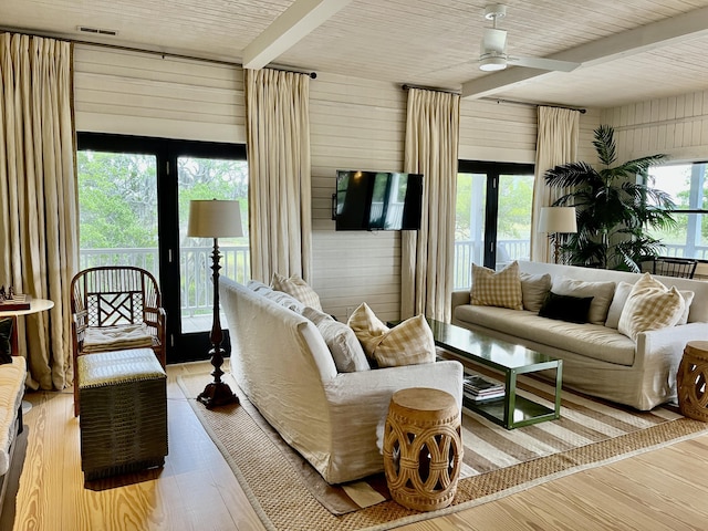 sunroom with beamed ceiling, visible vents, and a ceiling fan