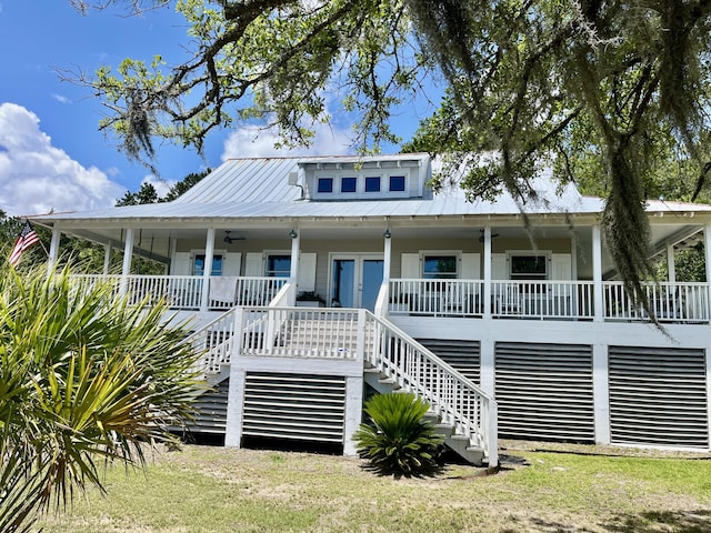 view of front of house with stairs, metal roof, a porch, and french doors