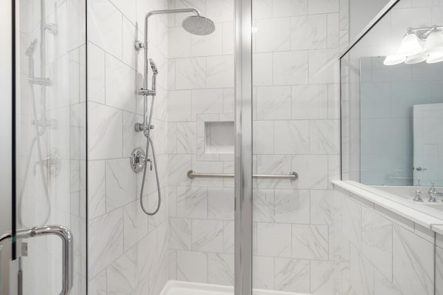 bathroom featuring a shower with door