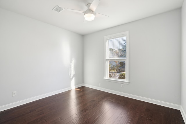 spare room with dark wood-type flooring and ceiling fan