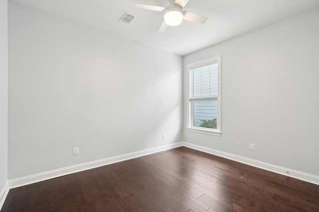 spare room with dark hardwood / wood-style flooring and ceiling fan