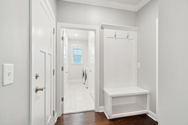 mudroom featuring washer and clothes dryer, crown molding, and dark hardwood / wood-style flooring