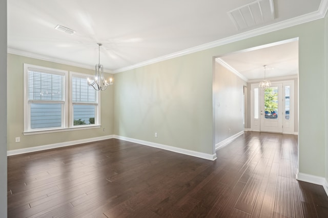 empty room featuring dark wood-type flooring, crown molding, and a chandelier