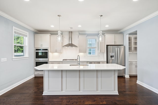 kitchen featuring pendant lighting, wall chimney exhaust hood, dark wood-type flooring, and a kitchen island with sink