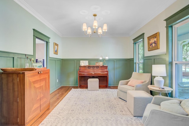 4227 Sawgrass Dr, North Charleston, SC 29420 - living area featuring wood finished floors, a chandelier, crown molding, wainscoting, and a decorative wall