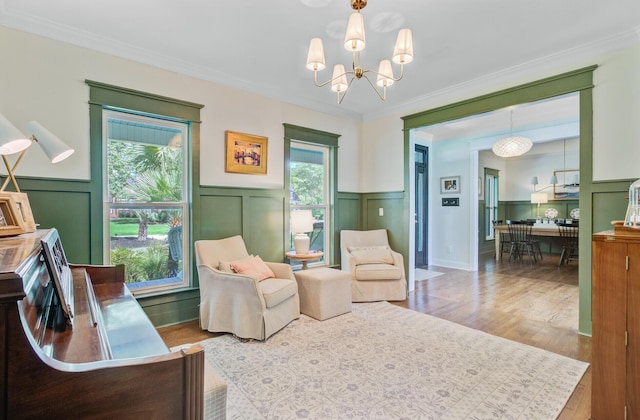 4227 Sawgrass Dr, North Charleston, SC 29420 - living area with a decorative wall, a chandelier, plenty of natural light, wood finished floors, and wainscoting