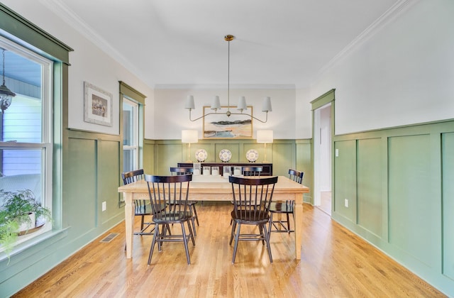 4227 Sawgrass Dr, North Charleston, SC 29420 - dining space with a decorative wall, ornamental molding, light wood-style flooring, and a wainscoted wall
