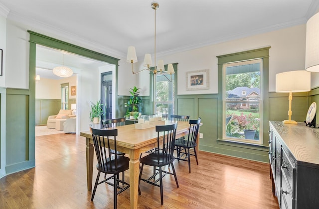 4227 Sawgrass Dr, North Charleston, SC 29420 - dining space featuring ornamental molding, a decorative wall, plenty of natural light, light wood-style floors, and a wainscoted wall