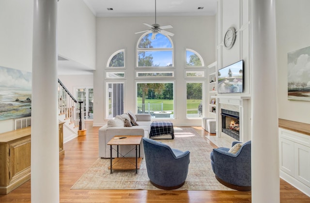 4227 Sawgrass Dr, North Charleston, SC 29420 - living area featuring light wood-style floors, plenty of natural light, ceiling fan, a fireplace with flush hearth, and ornamental molding