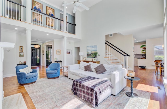 4227 Sawgrass Dr, North Charleston, SC 29420 - living area with ceiling fan, wood finished floors, stairs, a towering ceiling, and ornate columns