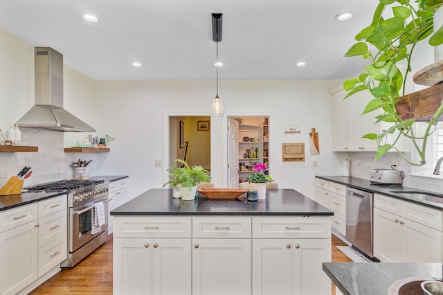 4227 Sawgrass Dr, North Charleston, SC 29420 - kitchen featuring wall chimney exhaust hood, stainless steel appliances, a sink, dark countertops, and white cabinets