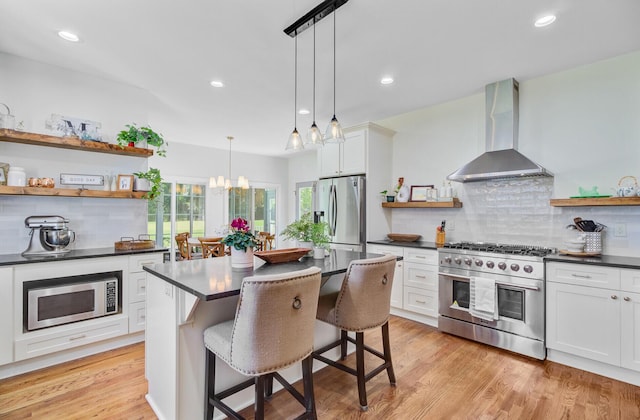 4227 Sawgrass Dr, North Charleston, SC 29420 - kitchen featuring appliances with stainless steel finishes, open shelves, wall chimney exhaust hood, dark countertops, and tasteful backsplash