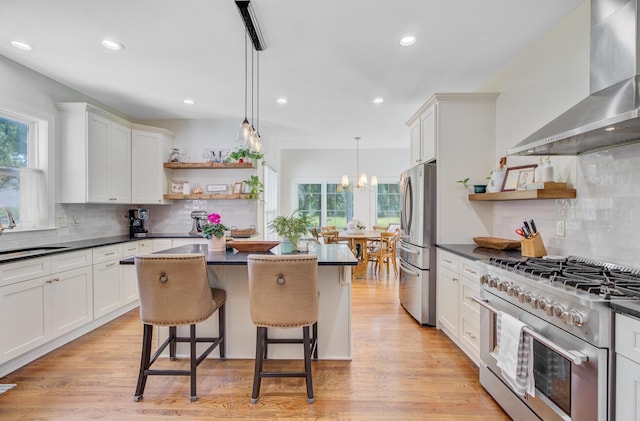 4227 Sawgrass Dr, North Charleston, SC 29420 - kitchen featuring open shelves, appliances with stainless steel finishes, wall chimney range hood, dark countertops, and recessed lighting
