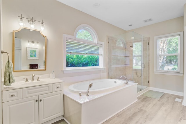 4227 Sawgrass Dr, North Charleston, SC 29420 - full bath featuring a bath, vanity, a shower stall, wood finished floors, and baseboards