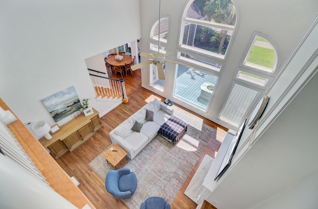 4227 Sawgrass Dr, North Charleston, SC 29420 - living room with a towering ceiling, wood finished floors, and stairs