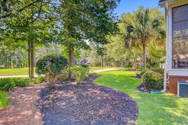 4227 Sawgrass Dr, North Charleston, SC 29420 - view of green lawn featuring view of wooded area and central AC
