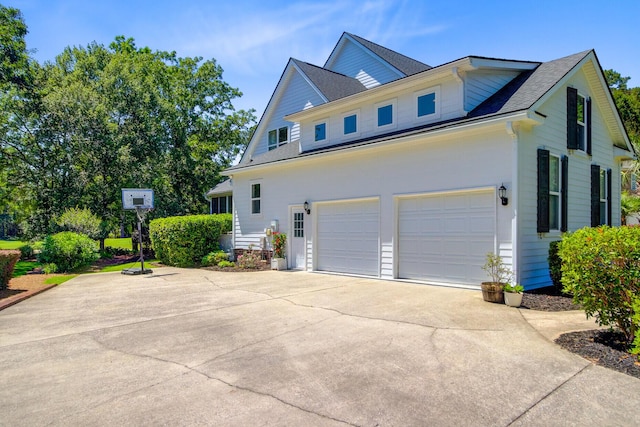 4227 Sawgrass Dr, North Charleston, SC 29420 - view of side of home with an attached garage, concrete driveway, and roof with shingles