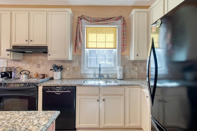 kitchen with backsplash, sink, white cabinets, and black appliances