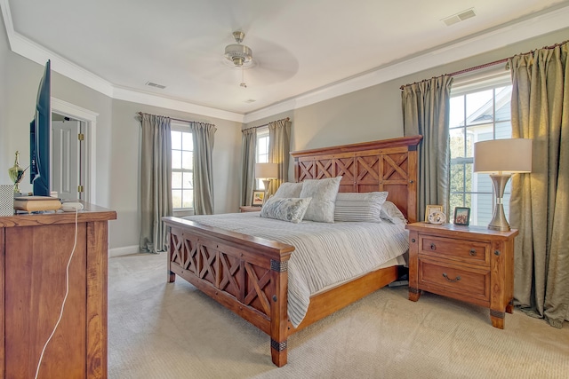 carpeted bedroom featuring ceiling fan, ornamental molding, and multiple windows