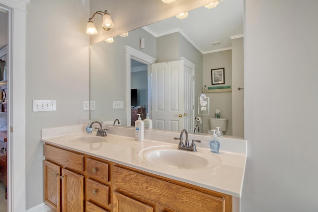 bathroom featuring vanity, toilet, and ornamental molding