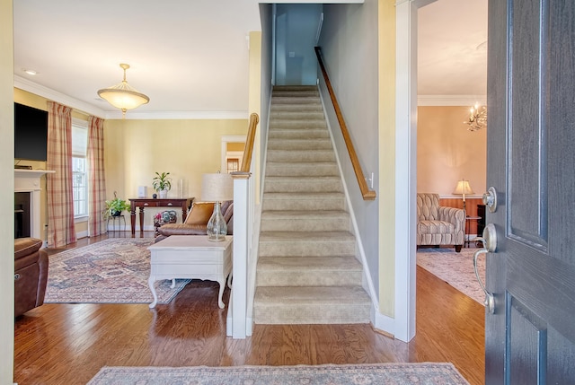 interior space with hardwood / wood-style floors, a notable chandelier, and ornamental molding