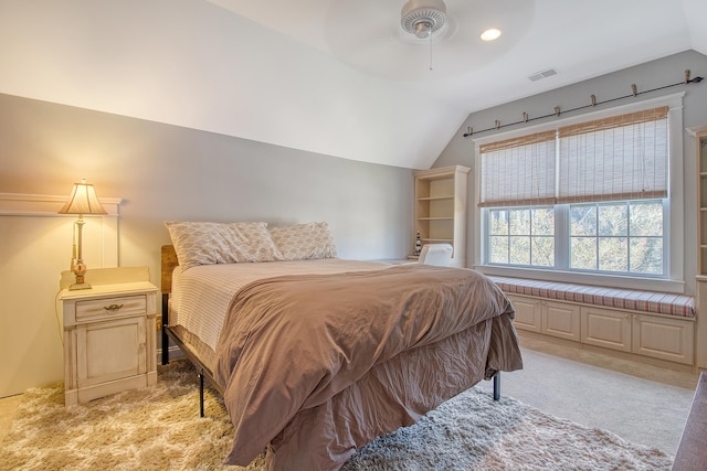 bedroom featuring ceiling fan, light colored carpet, and lofted ceiling