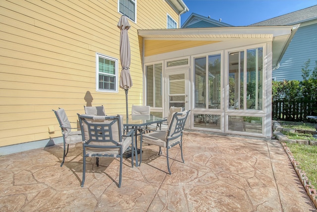 view of patio featuring a sunroom