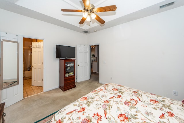 carpeted bedroom with a barn door, a spacious closet, and ceiling fan