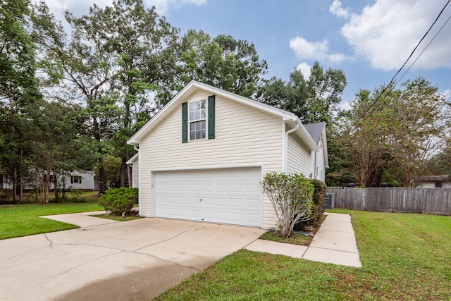 view of side of home featuring a lawn, a garage, and central air condition unit